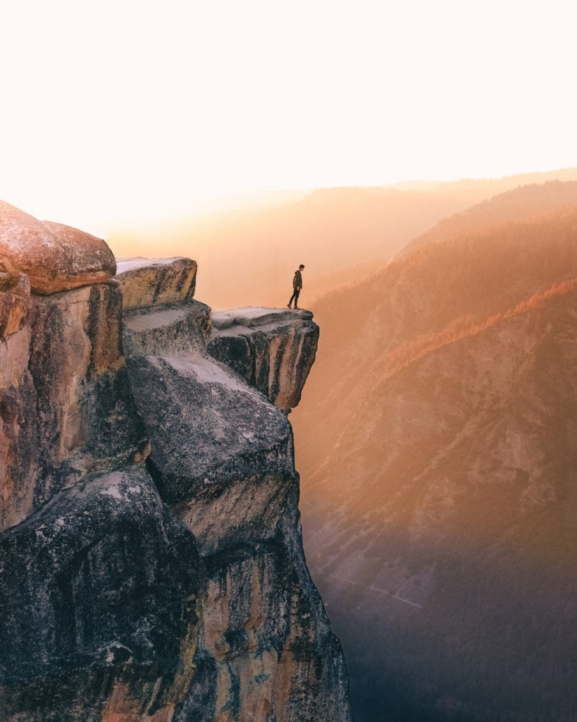 Man on the edge of a cliff in Yosemite, a metaphor for taking the leap into video marketing