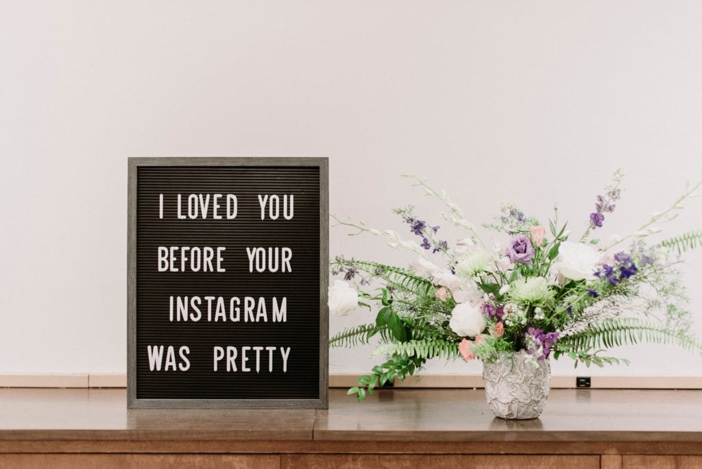 frame with text stating "I loved you before your instagram was pretty" on furniture