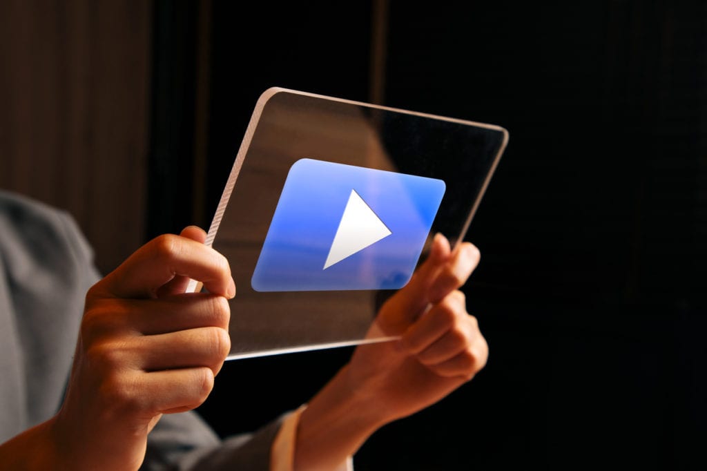 cropped-photo-of-hands-holding-transparent-tablet-with-video-play-button-in-blue