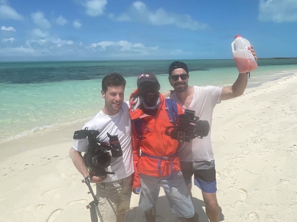 Camera crew celebrating on a beach